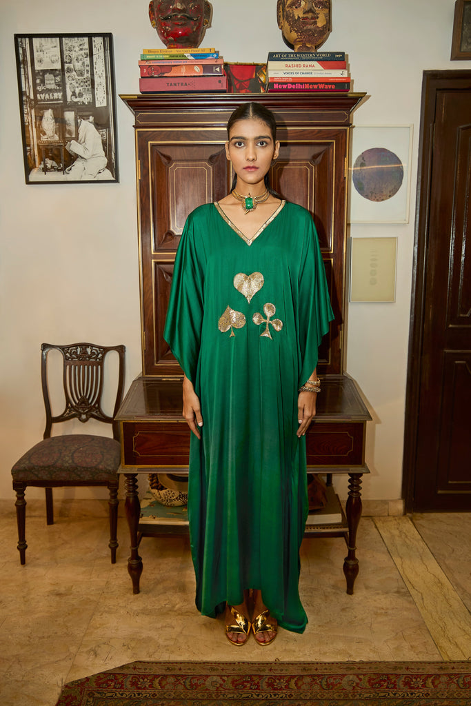 spades satin dress Elegant woman in black satin dress holding ace of spades